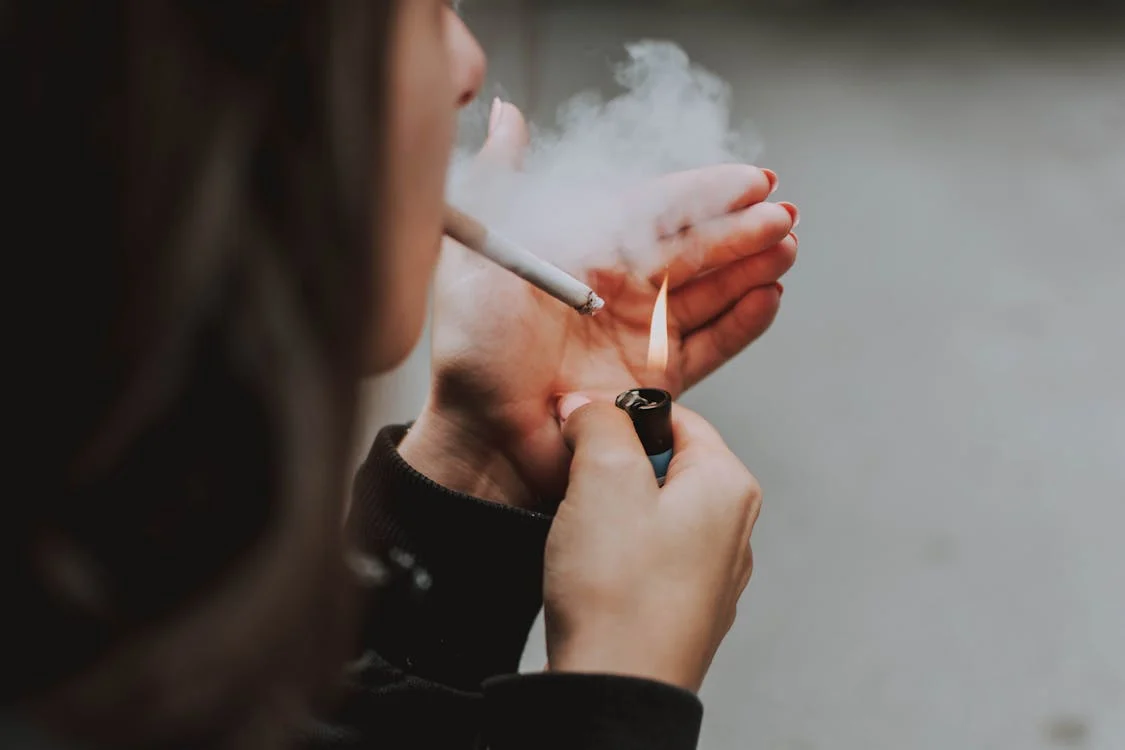 An image of addicted girls lighting a cigerate for smoking