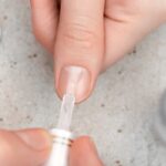 A girl using Builder gel to manicure her hands nail