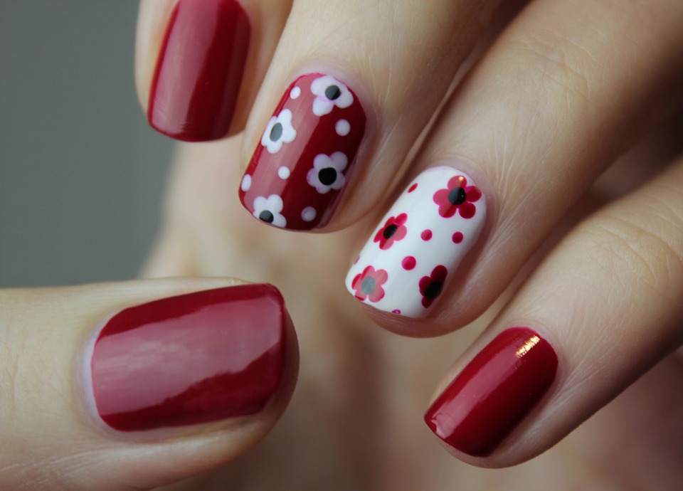 Nail Art. A girl has painted her nail with different shapes and shades